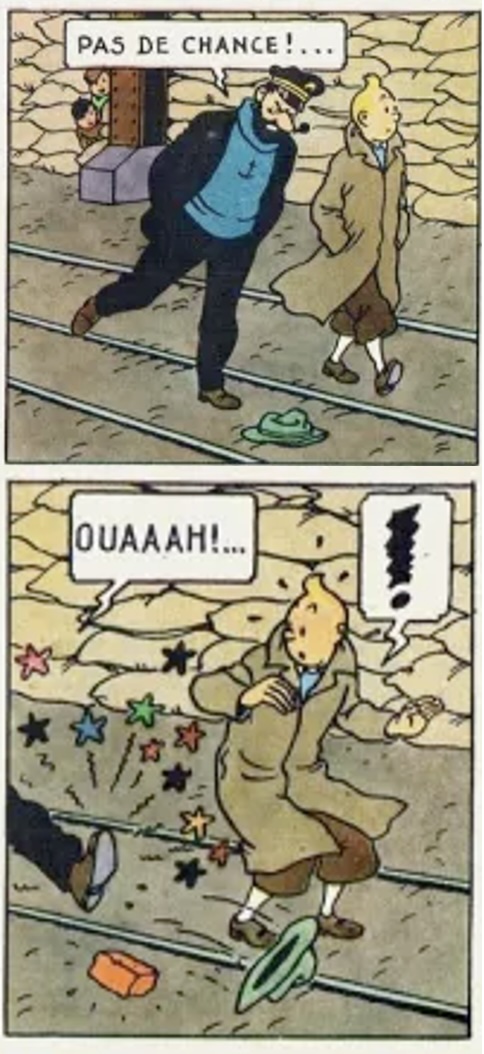Haddock donne un coup de pied dans un chapeau (qui cache une brique)